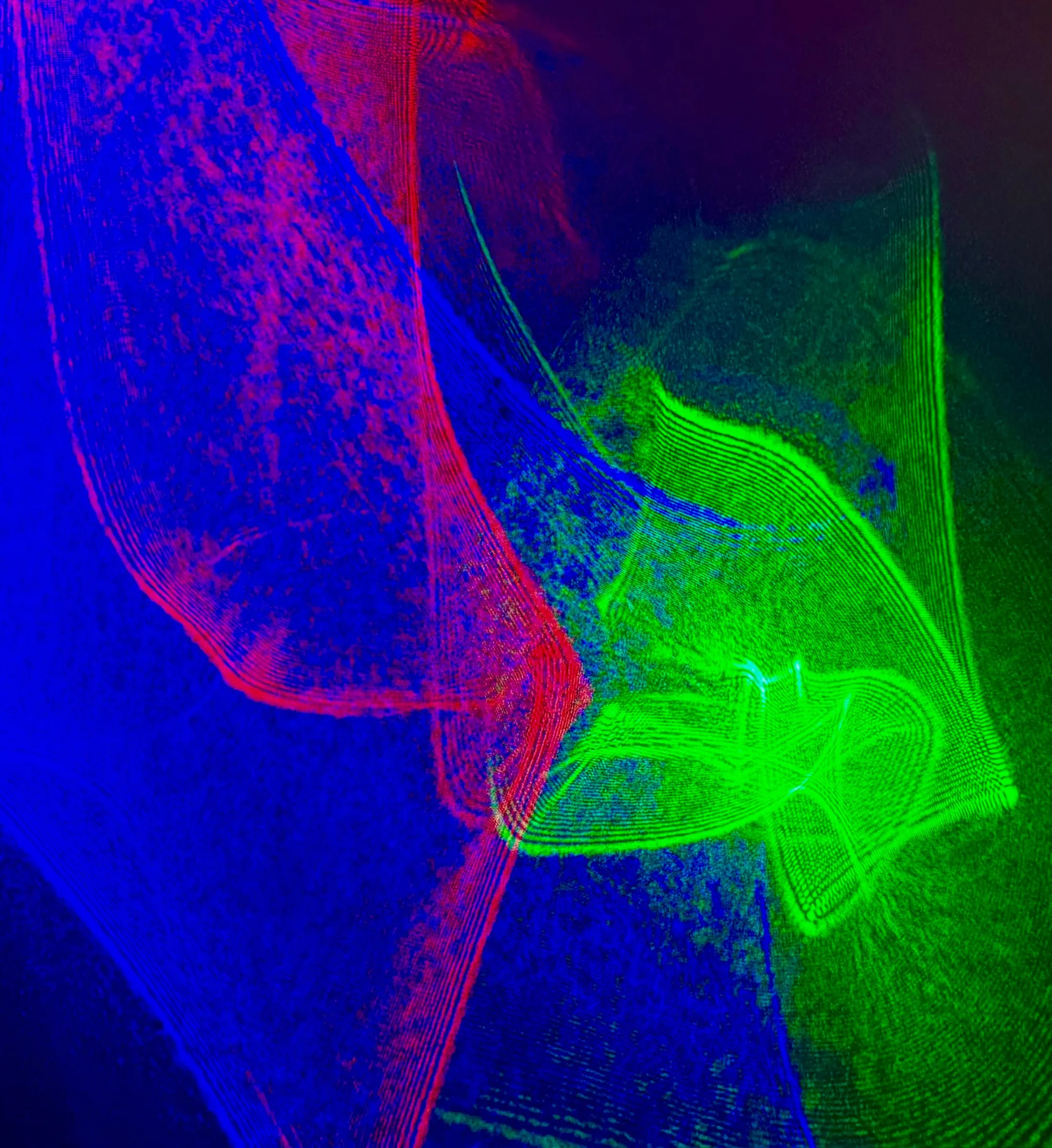 Sweeping ribbons of red, green, and blue laser light — a lumia composition made with Paul Linden's laser systems.