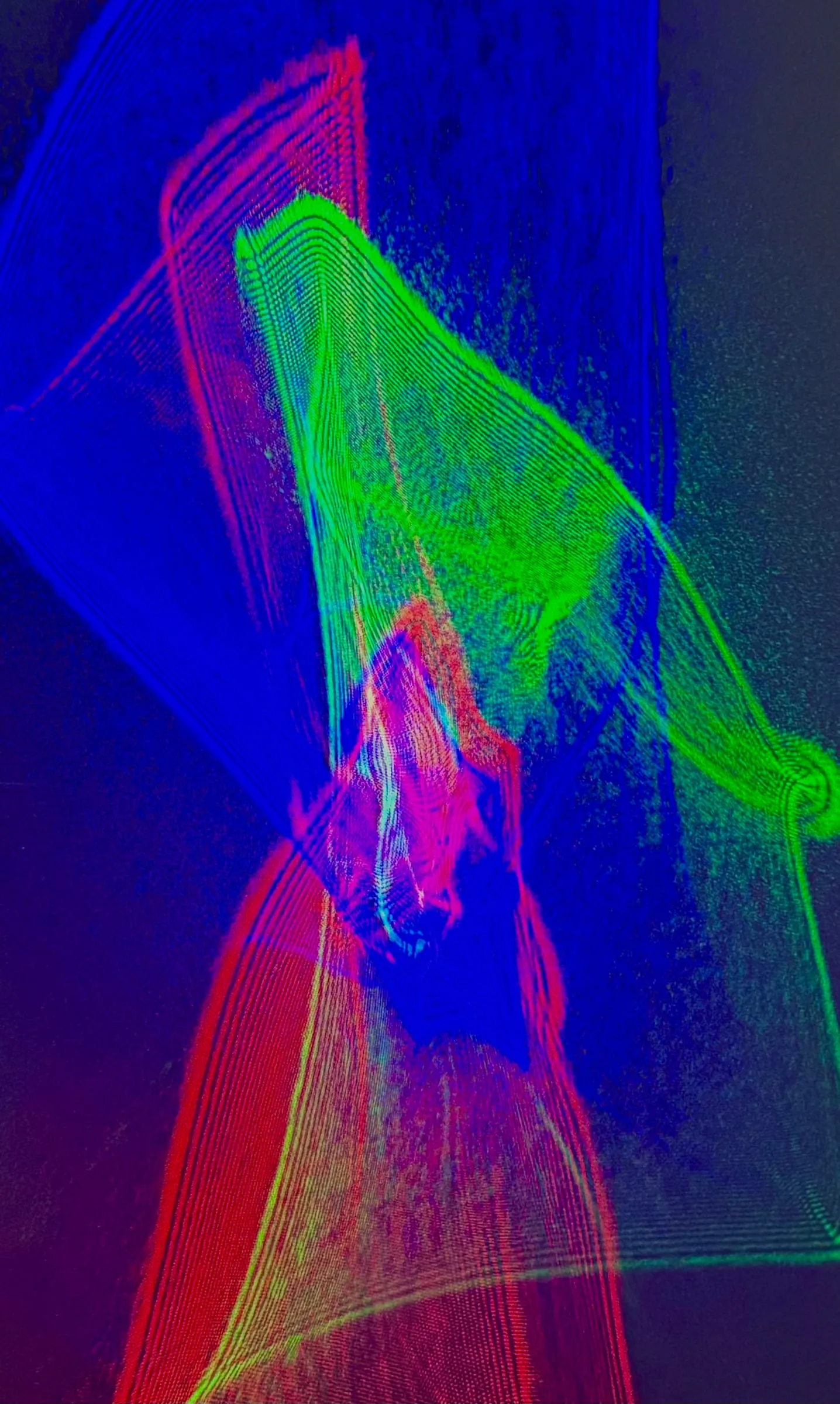 An abstract composition of red, green, and blue laser light.